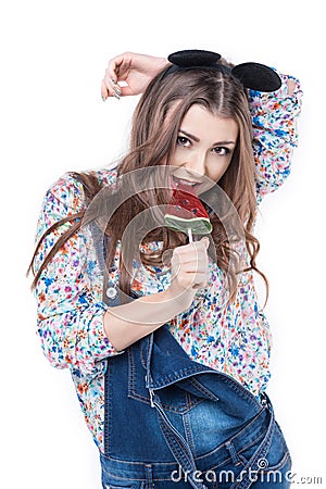 Young cheerful woman sucks lollipop Stock Photo