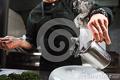Young chef preparing modern molecular dish with liquid nitrogen Stock Photo