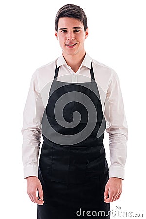 Young chef or waiter wearing black apron isolated Stock Photo