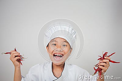 Young chefs hold chili in both hands Stock Photo