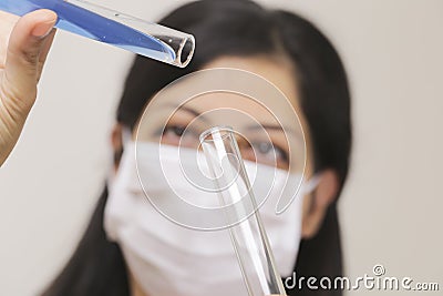 Young chemical female researcher holding in laboratory Stock Photo