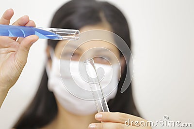 Young chemical female researcher holding in laboratory Stock Photo