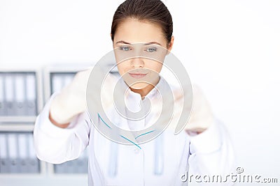 Young chemical female researcher holding two glass tubes with fl Stock Photo