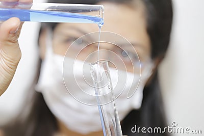 Young chemical female researcher holding two glass tubes Stock Photo