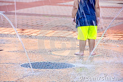 Young child in city splash pad Stock Photo