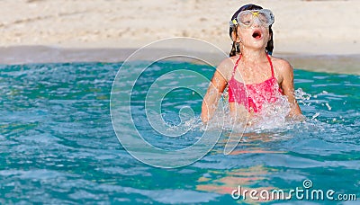 young child girl snorkelling in mask on tropical beach background Stock Photo