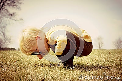 Young Child looking through Magnifying Glass Stock Photo