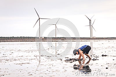 A Young Child Playing with Mud in Gaomei Wetlands Editorial Stock Photo