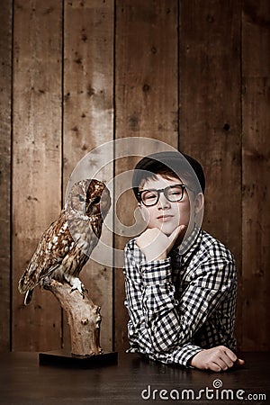 Young child, portrait and confident with thinking by owl, pride and vintage fashion with glasses in mockup. Boy, face Stock Photo