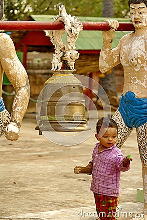 Child ringing a bell Editorial Stock Photo