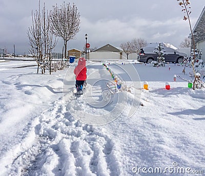 Young Child Shoveling Snow Stock Photo