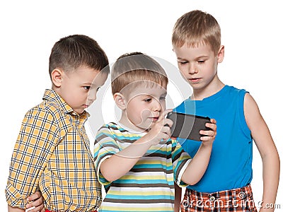 Young children plaing with a new gadget Stock Photo