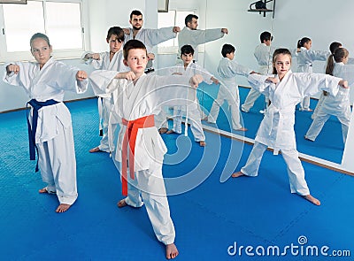 Children training karate kicks during karate class Stock Photo
