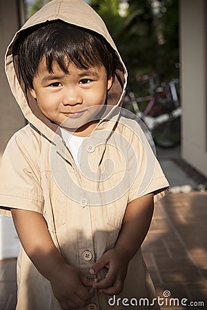 Young children wearing hood sweat with lovely face standing at h Stock Photo