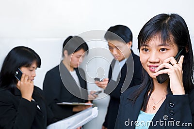 Young Chinese businesswoman talking on cell phone Stock Photo