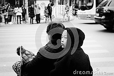 Young chinese girl with a black hood on the scooter Editorial Stock Photo