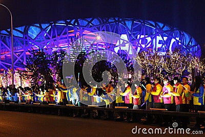Young Chinese welcome APEC leaders upon their arrival at China National Swimming Center Editorial Stock Photo