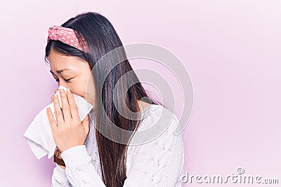 Young chinese woman illness wearing diadem using paper handkerchief on nose Editorial Stock Photo