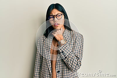 Young chinese woman wearing business style and glasses touching painful neck, sore throat for flu, clod and infection Stock Photo