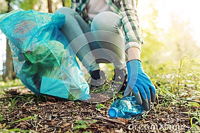 Young cleanup volunteer collecting trash in the forest Stock Photo