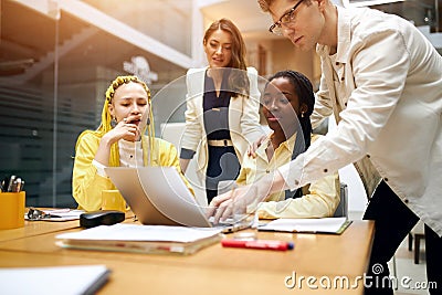 Young clever computer hacker overcoming problem Stock Photo