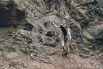 Young climber woman standing near the rock Stock Photo