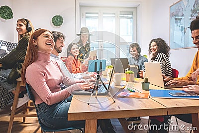 Young co-workers team talking during startup - Happy people planning a new project in creative coworking office - Technology, Stock Photo