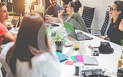 Young co-workers team talking during startup - Happy people planning a new project in creative workplace office - Focus on right Stock Photo