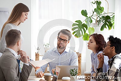 Young coach woman presenting report to colleagues in office Stock Photo