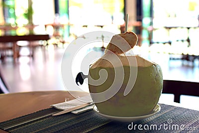 Young coconut ready to drink at the restaurant. Stock Photo