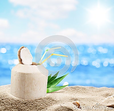 Young coconut in the sand at the beach. Stock Photo