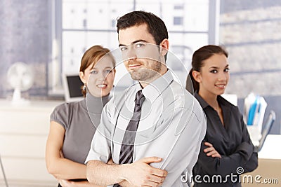 Young colleagues standing in office arms crossed Stock Photo