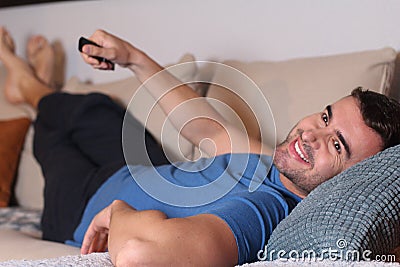 Young comfortable man watching tv Stock Photo