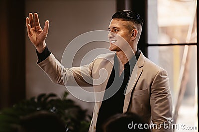 Young and Confident CEO or Coach Speaker in Seminar or Meeting Room at Modern Creative Office. Mentor Leader Explaining Strategy Stock Photo