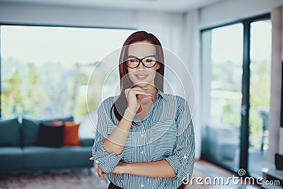 Young confident smart woman posing in living room Stock Photo