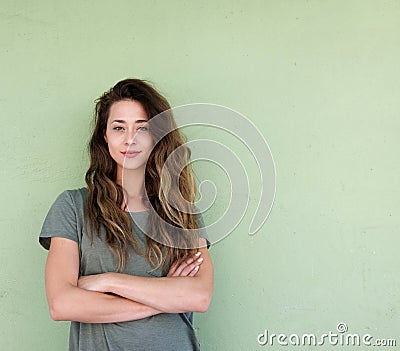 Young confident woman standing with arms crossed Stock Photo