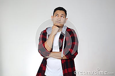 Young confused Asian man thinking expression, looking up contemplation gesture over white Stock Photo