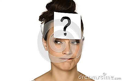A young confused woman with a drawn question mark on paper Stock Photo