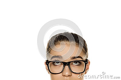 Young confused woman with glasses looking up Stock Photo
