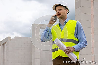 Construction engineer supervisor working at building site. talking on the phone Stock Photo