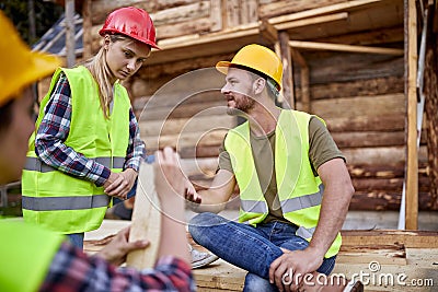 Young construction workers man and woman talking.Teamwork.Building. woodworking team work creatively Stock Photo