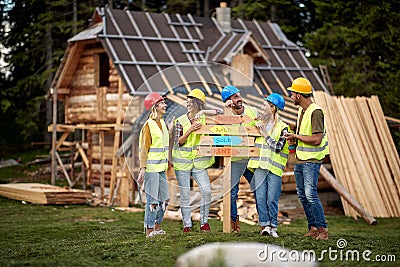 Young construction workers.Teamwork.Building. woodworking team work creatively Stock Photo