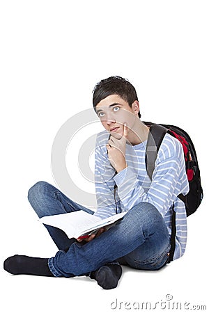 Young contemplative male student sitting on floor Stock Photo