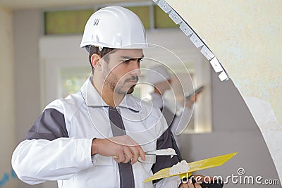 Young contractor pargets ceiling Stock Photo