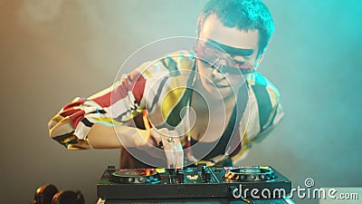 Young cool artist working as dj with turntables Stock Photo