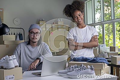 Young couple of Asian man and African-American woman retail seller, entrepreneur, online store drop shipping small business owner Stock Photo