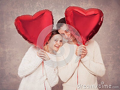 Young couple with balloons in the form of heart Stock Photo