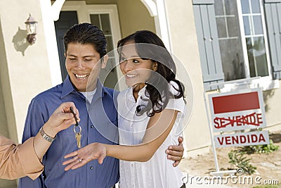 Young couple buying house taking keys Stock Photo