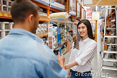 Young couple buying repair tools in hardware store Stock Photo