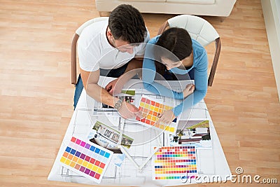 Young couple choosing color from swatch Stock Photo